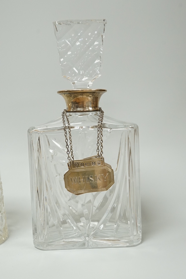 A late Victorian silver mounted cut glass mug, Saunders & Shepherd, Chester, 1899, height 13.4cm, together with a modern silver mounted cut glass decanter and a modern pair of silver 'Whisky' and 'Brandy' wine labels, J.